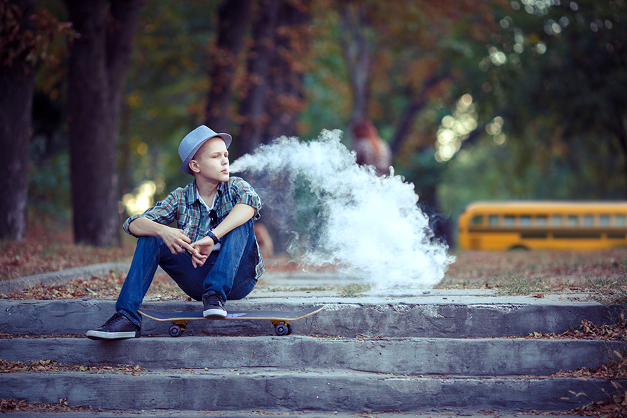 Teenager vaping on campus.