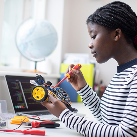 Female Teenage Pupil Building Robot Car In Science Lesson